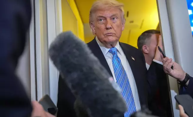 FILE - President Donald Trump speaks to reporters aboard Air Force One, May 15, 2026, as he returns from a trip to Beijing, China. (AP Photo/Mark Schiefelbein, File)