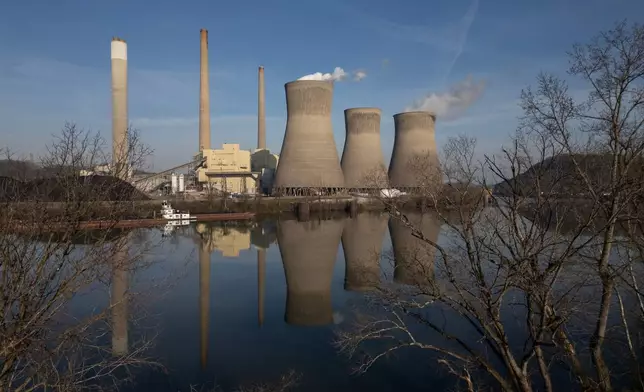 FILE - American Electric Power's John Amos coal-fired power plant in Winfield, W.Va., is seen across the Kanawha River from Poca, W.Va., March 22, 2026. (AP Photo/Carolyn Kaster, File)