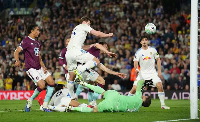 Leeds United's Dominic Calvert-Lewin, second from left, scores their side's third goal during the Premier League match between Leeds United and Burnley, in Leeds, England, Friday, May 1, 2026. (Martin Rickett/PA via AP)
