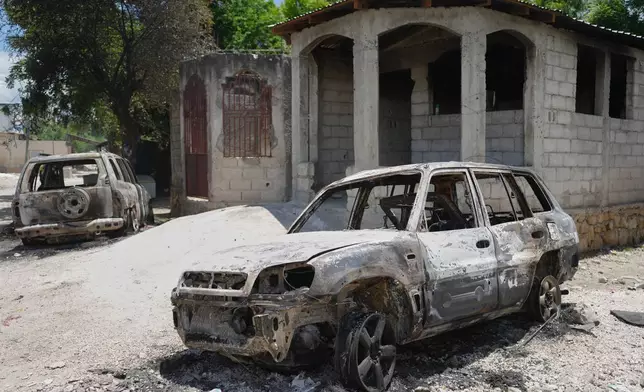 Vehicles that were set on fire by armed gangs sit in the Cite Soleil neighborhood of Port-au-Prince, Haiti, Tuesday, May 12, 2026. (AP Photo/Odelyn Joseph)