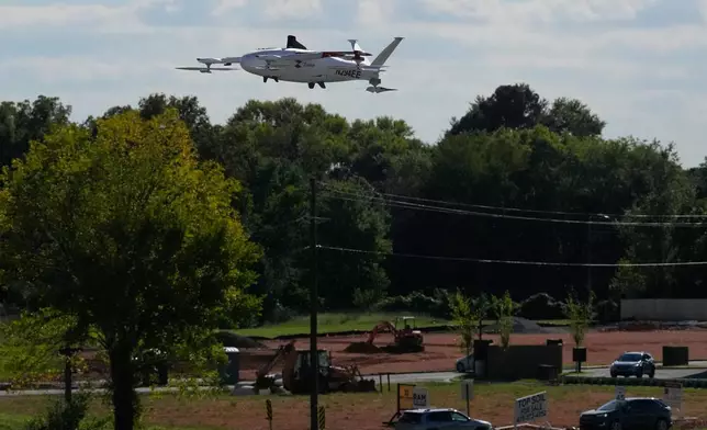 A drone operated by Zipline flies to make a delivery from a Walmart store in Pea Ridge, Ark., Friday, Sept. 26, 2025. (AP Photo/Charlie Riedel)