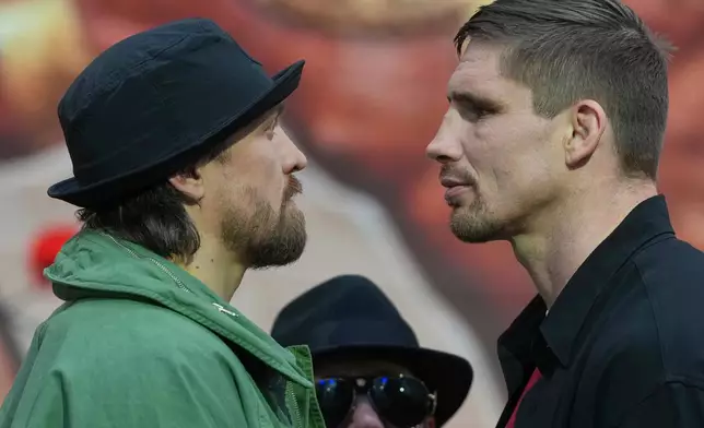 FILE -Boxers Oleksandr Usyk, left, and Rico Verhoeven face off during a press conference to announce their upcoming WBC World Heavyweight Championship boxing match, in London, April 14, 2026. (AP Photo/Alastair Grant, File)