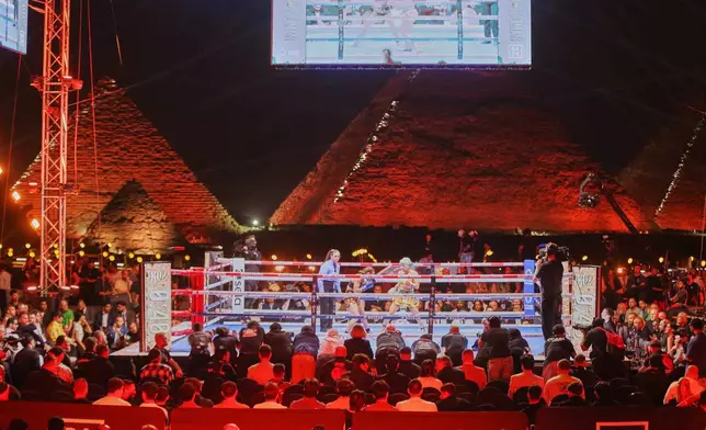 Japan's Mizuki Hiruta, right, battles Egyptian-born Australian boxer Mai Soliman in a WBO junior bantamweight title boxing match at the site of the Pyramids of Giza, Saturday, May 23, 2026, in Giza, Egypt. (AP Photo)