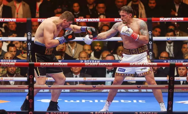 Oleksandr Usyk, right, battles Rico Verhoeven, left, during a boxing match at the WBC World Heavyweight Championship "Glory in Giza" at the site of the Pyramids of Giza, Sunday, May 24, 2026, in Giza, Egypt. (AP Photo)
