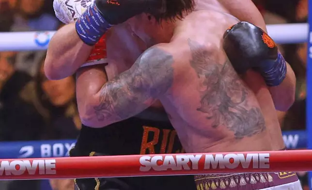 Oleksandr Usyk, front, battles Rico Verhoeven, back, during a boxing match at the WBC World Heavyweight Championship "Glory in Giza" at the site of the Pyramids of Giza, Sunday, May 24, 2026, in Giza, Egypt. (AP Photo)