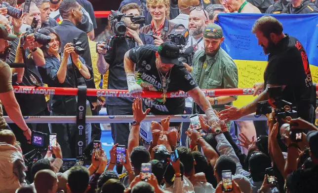 Oleksandr Usyk, center, greets his fans after winning his boxing match against Rico Verhoeven during the WBC World Heavyweight Championship "Glory in Giza" at the site of the Pyramids of Giza, Sunday, May 24, 2026, in Giza, Egypt. (AP Photo)