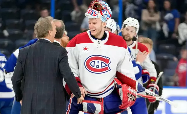 Montréal Canadiens goaltender Jakub Dobes talks to Tampa Bay Lightning head coach Jon Cooper after the Canadiens defeated the Lightning in Game 7 of an NHL hockey Stanley Cup first-round playoff series, Sunday, May 3, 2026, in Tampa, Fla. (AP Photo/Chris O'Meara)