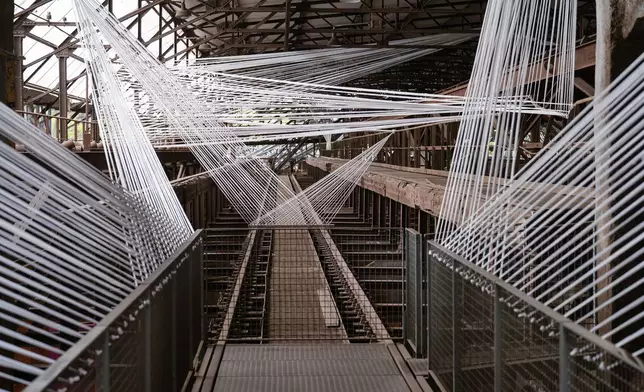 The installation "Transit der Erinnerung", Transit of Memory, by artist Vortex-X is on display at the at the former ironworks Voelklinger Huette, World Cultural Heritage Site, as part of the exhibition Urban Art Biennale 2026 in Voelklingen, Germany, Wednesday, May 6, 2026. (Oliver Dietze/dpa via AP)