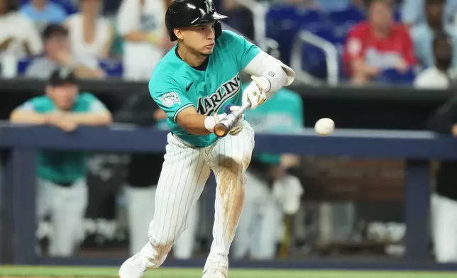 Miami Marlins' Javier Sanoja hits a sacrifice bunt during the ninth inning of a baseball game against the New York Mets, Sunday, May 24, 2026, in Miami. (AP Photo/Lynne Sladky)