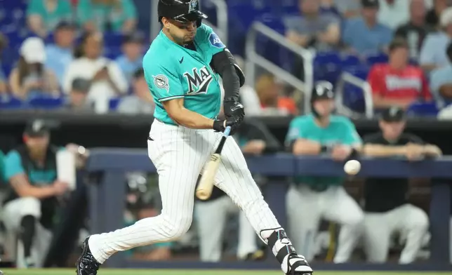 Miami Marlins' Christopher Morel hits a single during the ninth inning of a baseball game against the New York Mets, Sunday, May 24, 2026, in Miami. (AP Photo/Lynne Sladky)