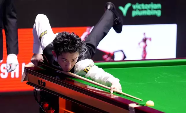 China's Wu Yize during his match against England's Shaun Murphy on day sixteen of the World Snooker Championship 2026 in Sheffield, England, Sunday, May 3, 2026. (Mike Egerton/PA via AP)