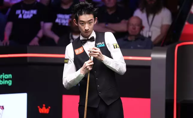 China's Wu Yize during his match against England's Shaun Murphy on day sixteen of the World Snooker Championship 2026 in Sheffield, England, Sunday, May 3, 2026. (Mike Egerton/PA via AP)