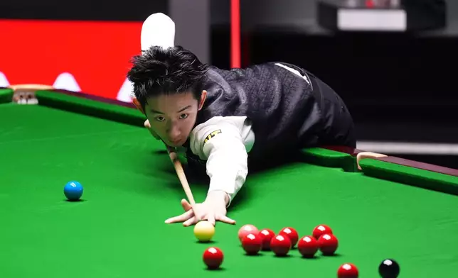 China's Wu Yize during his match against England's Shaun Murphy on day sixteen of the World Snooker Championship 2026 in Sheffield, England, Sunday, May 3, 2026. (Mike Egerton/PA via AP)