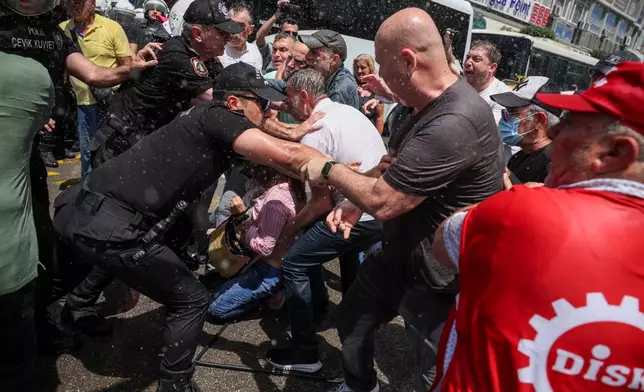 Police scuffle with supporters of Turkey's main opposition Republican People's Party (CHP) in Izmir, Turkey, Tuesday, May 26, 2026, during a rally in support of party's deposed leader Ozgur Ozel. (AP Photo/Erdem Sahin)