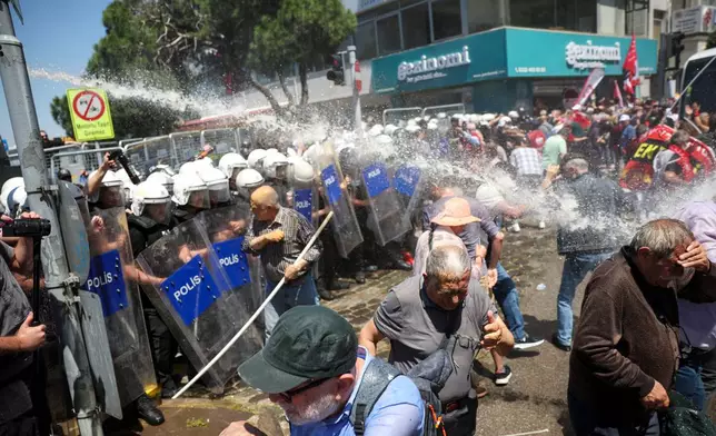 Police use water cannon to disperse supporters of Turkey's main opposition Republican People's Party (CHP) in Izmir, Turkey, Tuesday, May 26, 2026, during a rally in support of party's deposed leader Ozgur Ozel. (AP Photo/Erdem Sahin)
