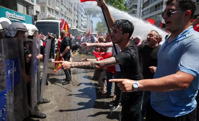 Police use water cannon to disperse supporters of Turkey's main opposition Republican People's Party (CHP) in Izmir, Turkey, Tuesday, May 26, 2026, during a rally in support of party's deposed leader Ozgur Ozel. (AP Photo/Erdem Sahin)