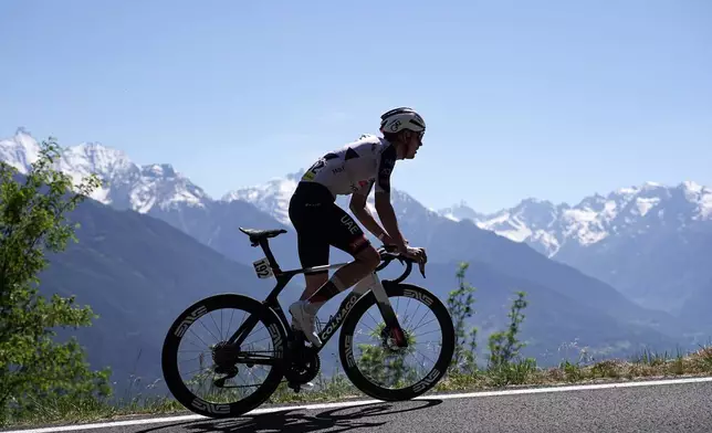 Spain's Igor Arrieta Lizarraga is backdropped by mountain peaks as he pedals during the 14th stage of the Giro d'Italia cycling race, from Aosta to Pila, Italy, Saturday, May 23, 2026. (Marco Alpozzi/LaPresse via AP)
