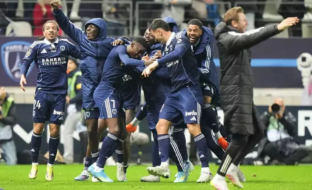 Paris FC's Alimami Gory, centre left, celebrates with teammates after scoring his side's second goal during the French League One soccer match between Paris FC and Paris Saint-Germain in Paris, Sunday, May 17, 2026. (AP Photo/Michel Euler)
