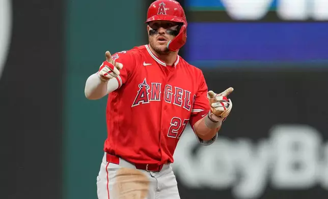 Los Angeles Angels' Mike Trout gestures from second base after hitting a double in the fifth inning of a baseball game against the Cleveland Guardians in Cleveland, Tuesday, May 12, 2026. (AP Photo/Sue Ogrocki)