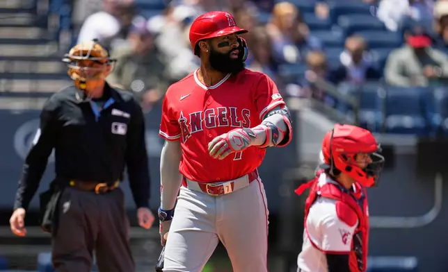 Los Angeles Angels' Jo Adell walks back to the dugout after striking out in the first inning of a baseball game against the Cleveland Guardians in Cleveland, Wednesday, May 13, 2026. (AP Photo/Sue Ogrocki)