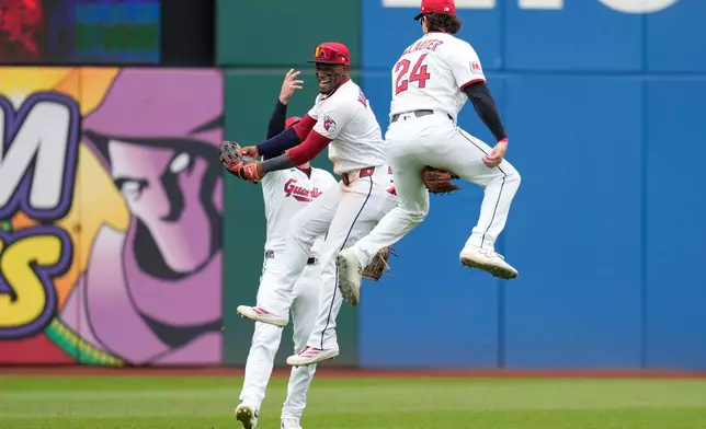 Cleveland Guardians' outfielders, Petey Halpin, left, Angel Martínez, center, and Chase DeLauter (24) celebrate after the Guardians defeated the Los Angeles Angels in a baseball game in Cleveland, Wednesday, May 13, 2026. (AP Photo/Sue Ogrocki)