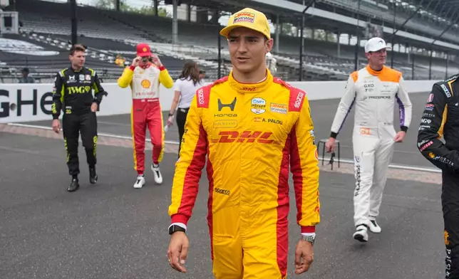 Alex Palou, of Spain, walks off the track after a photo session before practice for the Indianapolis 500 auto race at the Indianapolis Motor Speedway in Indianapolis, Monday, May 18, 2026. (AP Photo/Michael Conroy)