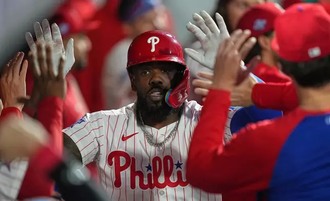 Philadelphia Phillies' Adolis García celebrates his home run off of Athletics pitcher Jeffrey Springs during the sixth inning of a baseball game, Wednesday, May 6, 2026, in Philadelphia. (AP Photo/Matt Rourke)