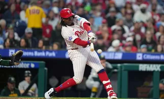 Philadelphia Phillies' Felix Reyes hits a one-run single off of Athletics pitcher Jeffrey Springs during the fifth inning of a baseball game, Wednesday, May 6, 2026, in Philadelphia. (AP Photo/Matt Rourke)