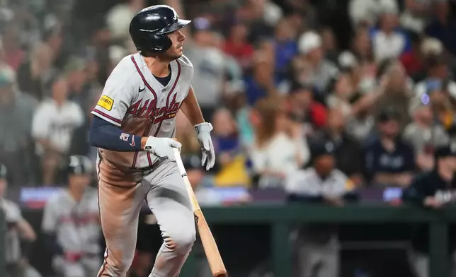 Atlanta Braves' Matt Olson watches his solo home run against the Seattle Mariners during the ninth inning of a baseball game, Tuesday, May 5, 2026, in Seattle. (AP Photo/Lindsey Wasson)