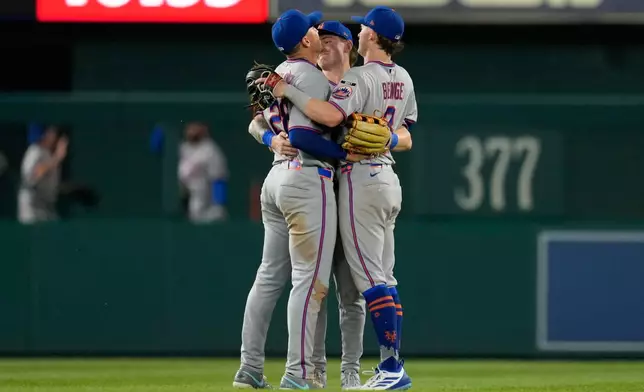 From left to right, New York Mets left fielder Tyrone Taylor, center fielder A.J. Ewing, and right fielder Carson Benge celebrate after winning a baseball game against the Washington Nationals, Monday, May 18, 2026, in Washington. (AP Photo/Jess Rapfogel)