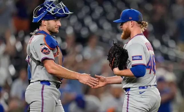 New York Mets catcher Hayden Senger, left, and pitcher Craig Kimbrel, right, celebrate after winning a baseball game against the Washington Nationals, Monday, May 18, 2026, in Washington. (AP Photo/Jess Rapfogel)