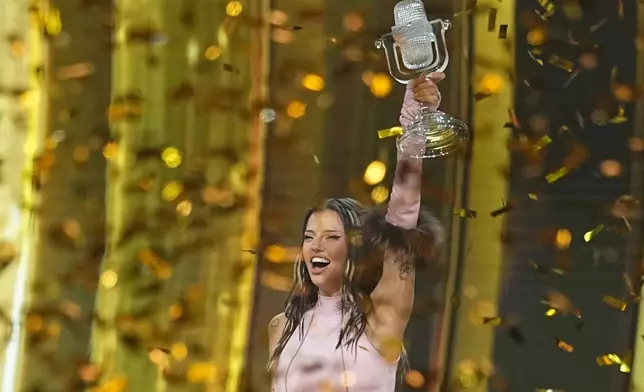 Dara from Bulgaria holds up the trophy after winning the Grand Final of the 70th Eurovision Song Contest in Vienna, Austria, Sunday, May 17, 2026. (AP Photo/Martin Meissner)