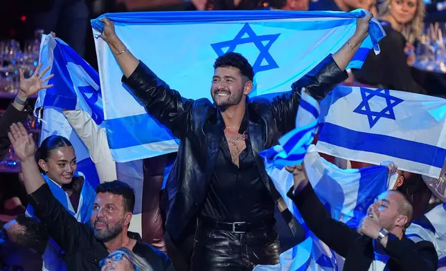 Noam Bettan from Israel, center, reacts as the points are awarded during the Grand Final of the 70th Eurovision Song Contest in Vienna, Austria, Sunday, May 17, 2026. (AP Photo/Martin Meissner)