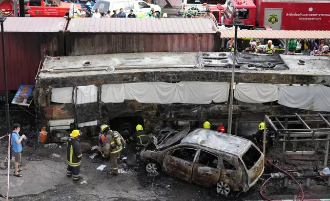 Rescuers work at a train crash site near an airport rail link station in Bangkok, Thailand, Saturday, May 16, 2026. (AP Photo/Sakchai Lalit)
