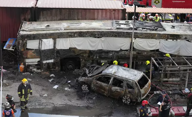 Rescuers work at a train crash site near Makkasan station in Bangkok, Thailand, Saturday, May 16, 2026. (AP Photo/Sakchai Lalit)