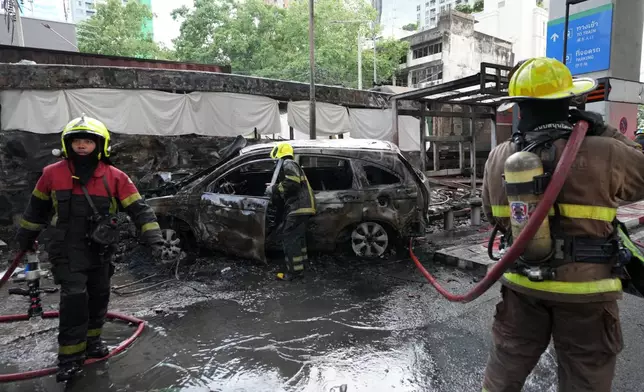 Rescuers work at a train crash site near an airport rail link station in Bangkok, Thailand, Saturday, May 16, 2026. (AP Photo/Sakchai Lalit)
