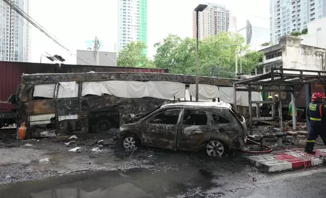 Damaged vehicles are seen at a train crash site near Makkasan station in Bangkok, Thailand, Saturday, May 16, 2026. (AP Photo/Sakchai Lalit)