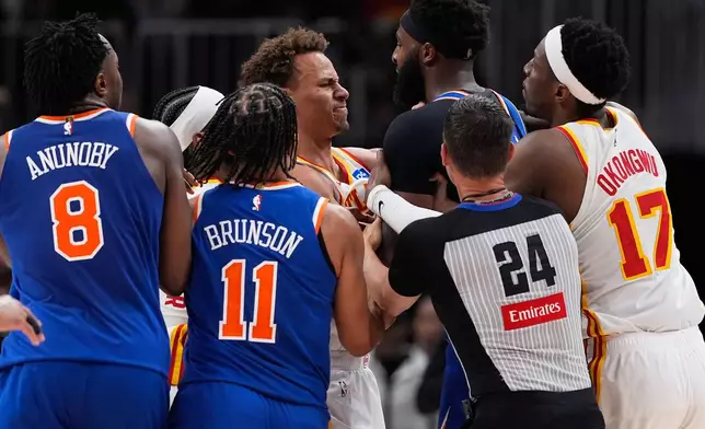 New York Knicks center Mitchell Robinson (23) and Atlanta Hawks guard Dyson Daniels (5) fight in the first half during Game 6 in a first-round NBA basketball playoffs series Thursday, April 30, 2026, in Atlanta. (AP Photo/Brynn Anderson)