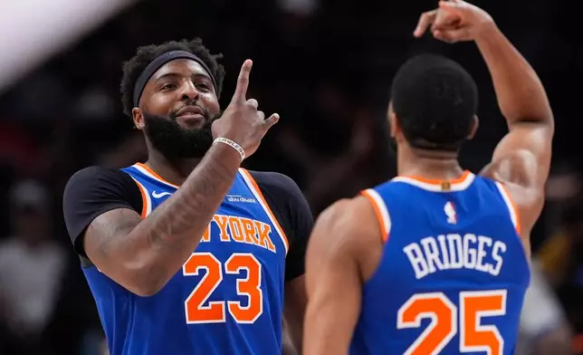 New York Knicks center Mitchell Robinson (23) celebrates after scoring in the first half during Game 6 in a first-round NBA basketball playoffs series against the Atlanta Hawks Thursday, April 30, 2026, in Atlanta. (AP Photo/Brynn Anderson)