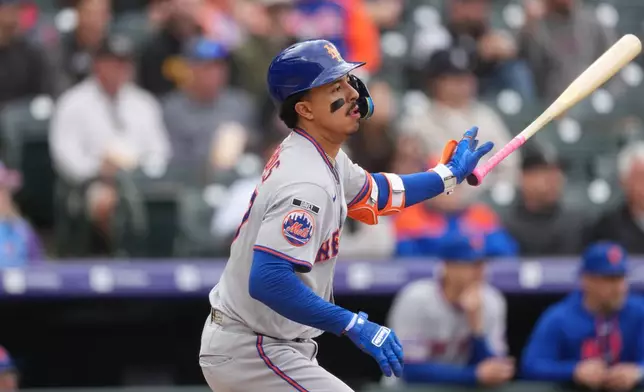 New York Mets' Mark Vientos follows the flight of his single to drive in two runs off Colorado Rockies relief pitcher Jaden Hill in the sixth inning of a baseball game Monday, May 4, 2026, in Denver. (AP Photo/David Zalubowski)