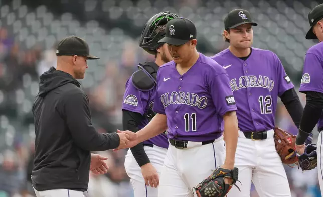 Colorado Rockies manager Warren Schaeffer, left, takes the ball from starting pitcher Tomoyuki Sugano (110 who is pulled from the mound after getting New York Mets' Bo Bichette to ground out in the sixth inning of a baseball game Monday, May 4, 2026, in Denver. (AP Photo/David Zalubowski)