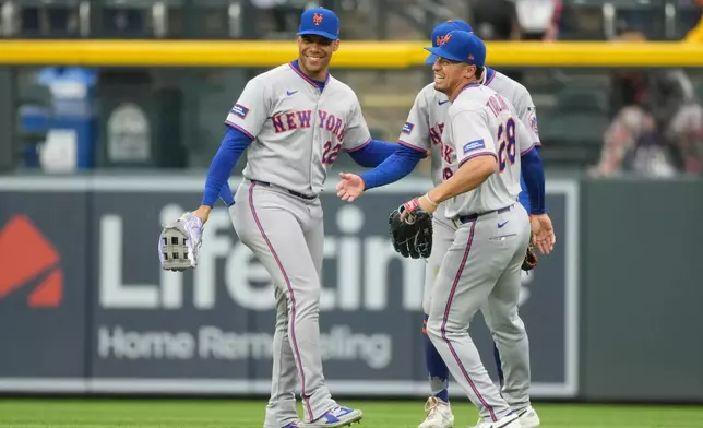 From left to right, New York Mets left fielder Juan Soto, center fielder Carson Benge and right fielder Tyrone Taylor celebrate after their team defeated the Colorado Rockies in a baseball game Monday, May 4, 2026, in Denver. (AP Photo/David Zalubowski)