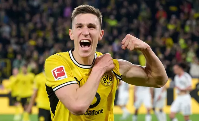 Borussia Dortmund's Nico Schlotterbeck celebrates scoring a goal during a Bundesliga soccer match between Borussia Dortmund and Eintracht Frankfurt, Friday, May 8, 2026, in Dortmund, Germany. (Bernd Thissen/dpa via AP)