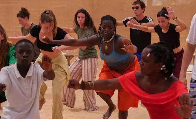 People attend a dance workshop at the Biennale of Dance in Africa, held at Ecole des Sables in Toubab Dialaw, Senegal, Saturday, May 2, 2026. (AP Photo/Misper Apawu)