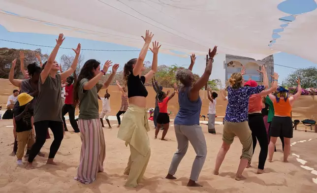 People attend a dance workshop at the Biennale of Dance in Africa, held at Ecole des Sables in Toubab Dialaw, Senegal, Saturday, May 2, 2026. (AP Photo/Misper Apawu)