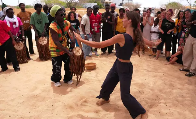 A lady performs at the Biennale of Dance in Africa, held at Ecole des Sables in Toubab Dialaw, Senegal, Saturday, May 2, 2026. (AP Photo/Misper Apawu)