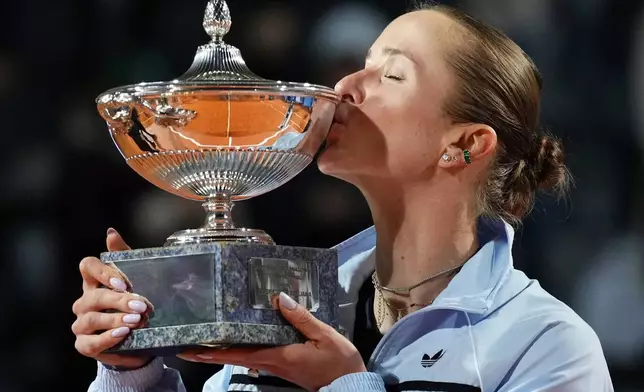 Ukraine's Elina Svitolina kisses the trophy after winning against United States' Coco Gauff at the end of the women's final match at the Italian Open tennis tournament in Rome, Saturday, May 16, 2026. (AP Photo/Alessandra Tarantino)