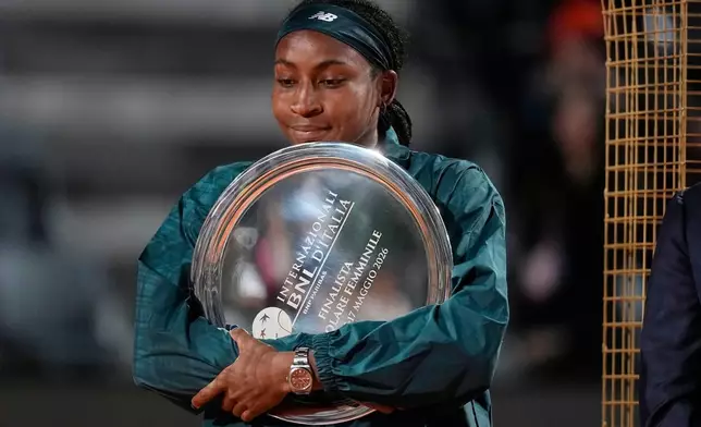 United States' Coco Gauff holds a trophy after playing against Ukraine's Elina Svitolina in the women's final match at the Italian Open tennis tournament in Rome, Saturday, May 16, 2026. (AP Photo/Alessandra Tarantino)