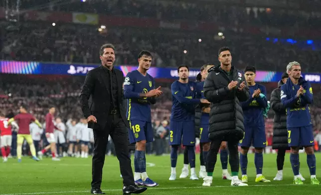 Atletico Madrid's head coach Diego Simeone and the players applaud the supporters at the the end of a Champions League semifinal, second leg, soccer match between Arsenal FC and Atletico Madrid in London, Tuesday, May 5, 2026. (AP Photo/Alastair Grant)