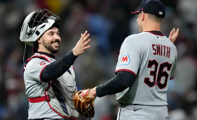 Cleveland Guardians' Austin Hedges, left, and Cade Smith celebrate after the Guardians won a baseball game against the Philadelphia Phillies Friday, May 22, 2026, in Philadelphia. (AP Photo/Matt Slocum)